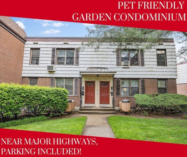 70-07 E Park Dr Unit A, Kew Garden Hills, NY 11367 - view of front of property with brick siding and a wall unit AC