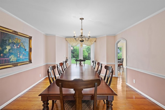 287 Old Army Rd, Scarsdale, NY 10583 - dining space featuring arched walkways, a chandelier, light wood-style floors, baseboards, and ornamental molding