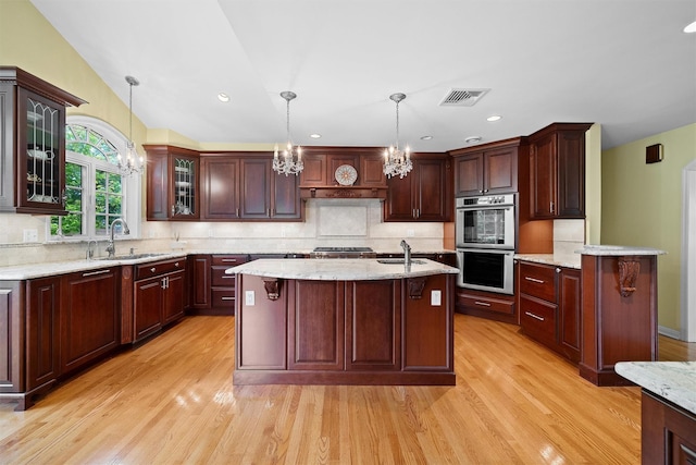 287 Old Army Rd, Scarsdale, NY 10583 - kitchen featuring a sink, double oven, a chandelier, light wood finished floors, and recessed lighting