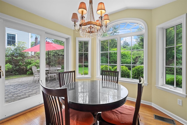 287 Old Army Rd, Scarsdale, NY 10583 - dining room with healthy amount of natural light, a chandelier, wood finished floors, baseboards, and vaulted ceiling