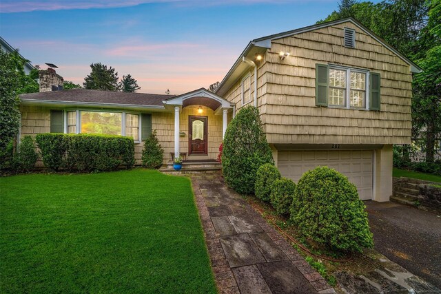 287 Old Army Rd, Scarsdale, NY 10583 - view of front of home featuring a lawn, an attached garage, a chimney, and asphalt driveway