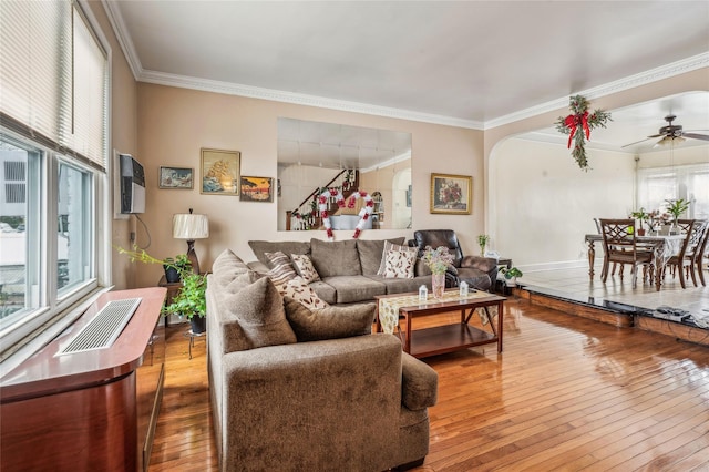 84-17 25th Ave, East Elmhurst, NY 11370 - living room featuring a ceiling fan, visible vents, arched walkways, ornamental molding, and hardwood / wood-style flooring