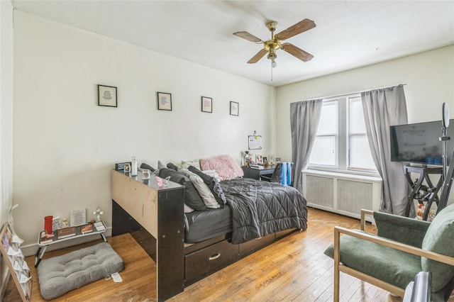 84-17 25th Ave, East Elmhurst, NY 11370 - bedroom with radiator heating unit, ceiling fan, and hardwood / wood-style flooring