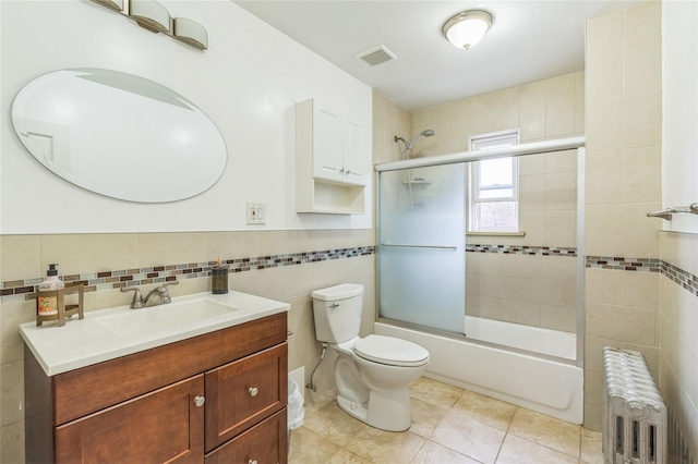 84-17 25th Ave, East Elmhurst, NY 11370 - bathroom featuring enclosed tub / shower combo, tile walls, visible vents, vanity, and radiator heating unit