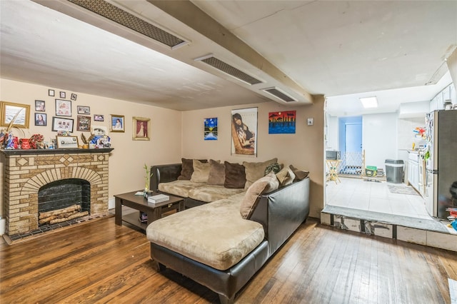 84-17 25th Ave, East Elmhurst, NY 11370 - living room with a fireplace, hardwood / wood-style floors, and visible vents
