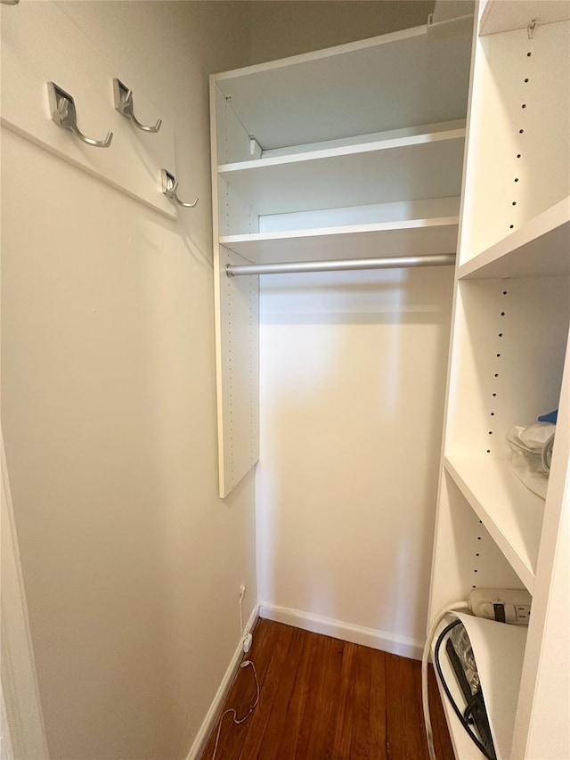 walk in closet featuring dark wood-type flooring