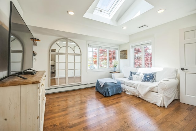 26 Forte Ave, Old Bethpage, NY 11804 - sitting room featuring a skylight, a baseboard heating unit, wood-type flooring, and recessed lighting