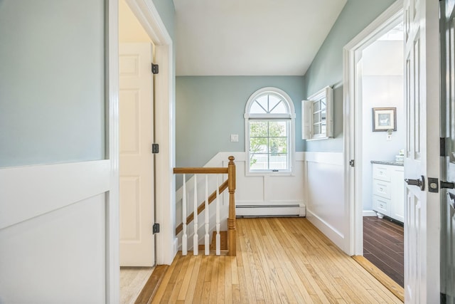 26 Forte Ave, Old Bethpage, NY 11804 - doorway to outside with baseboard heating and light wood-style flooring