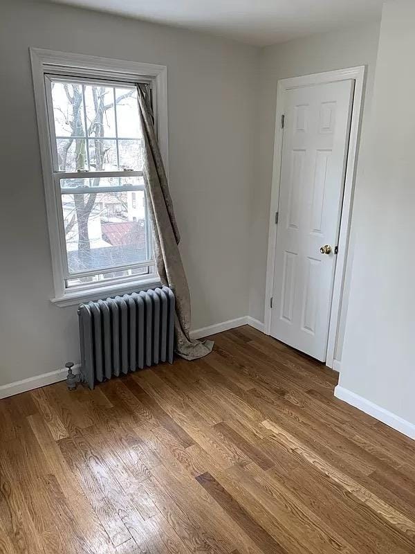 4565 Matilda Ave, Bronx, NY 10470 - unfurnished room with baseboards, radiator, and wood finished floors