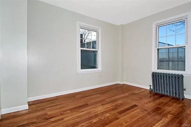 4565 Matilda Ave, Bronx, NY 10470 - empty room with baseboards, radiator heating unit, and wood finished floors