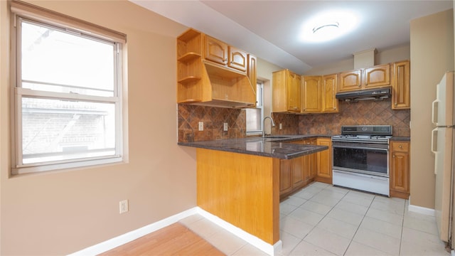 14322 Beech Ave, Flushing, NY 11355 - kitchen with gas range oven, under cabinet range hood, a peninsula, open shelves, and decorative backsplash