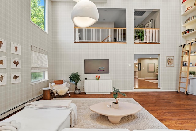 10 Spectrum Dr, Chester, NY 10918 - living room with radiator heating unit, a baseboard heating unit, wood finished floors, wallpapered walls, and baseboard heating