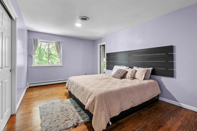 10 Spectrum Dr, Chester, NY 10918 - bedroom featuring baseboard heating, wood finished floors, baseboards, and a closet