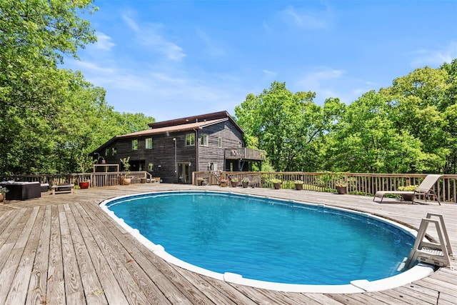 10 Spectrum Dr, Chester, NY 10918 - outdoor pool featuring a wooden deck and view of scattered trees