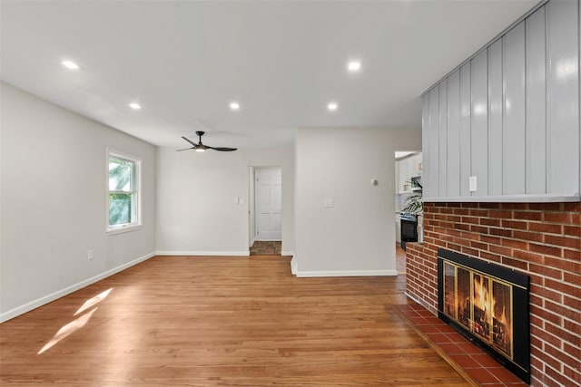 315 Scotchtown Rd, Goshen, NY 10924 - unfurnished living room featuring a brick fireplace, baseboards, recessed lighting, light wood-style flooring, and a ceiling fan