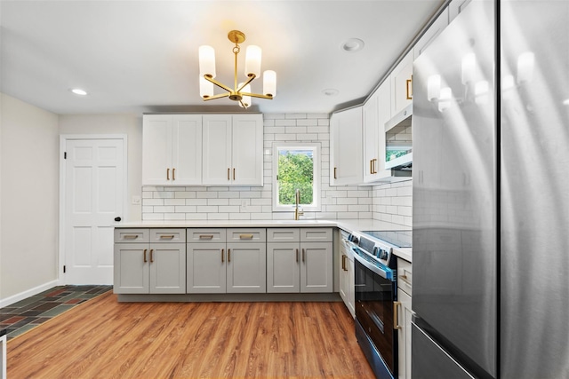 315 Scotchtown Rd, Goshen, NY 10924 - kitchen featuring appliances with stainless steel finishes, decorative backsplash, a chandelier, recessed lighting, and light countertops