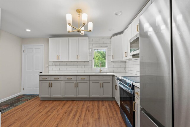 315 Scotchtown Rd, Goshen, NY 10924 - kitchen featuring stainless steel appliances, a sink, tasteful backsplash, a chandelier, and gray cabinetry