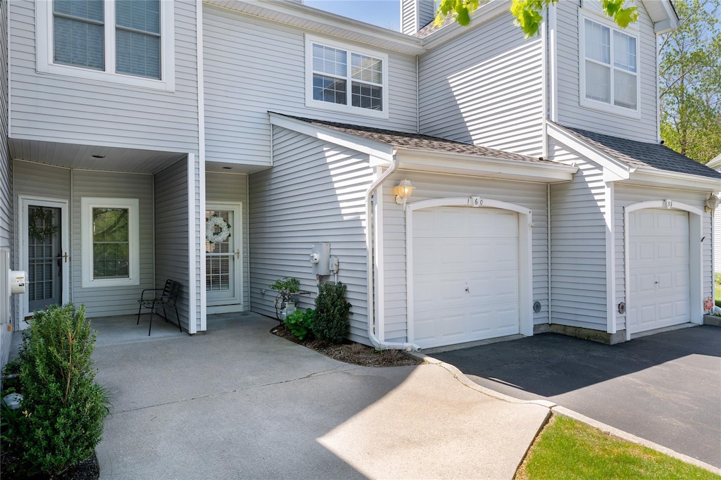 160 Windward Ct S, Port Jefferson, NY 11777 - exterior space with aphalt driveway, roof with shingles, and a garage
