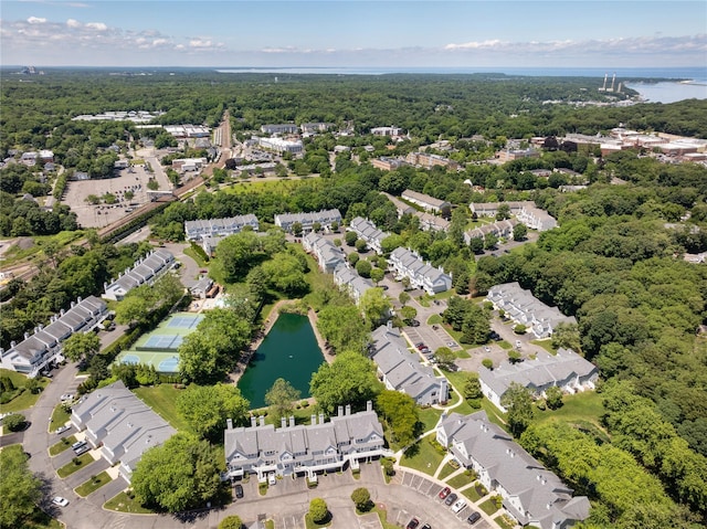 drone / aerial view featuring a water view and a view of trees