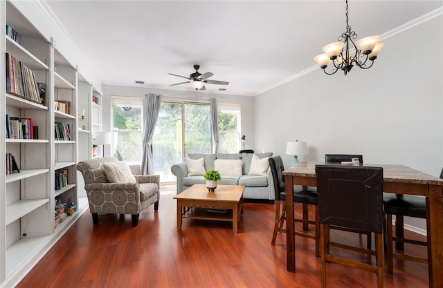 living room with crown molding, dark wood-style floors, and ceiling fan with notable chandelier
