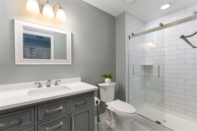 full bathroom with vanity, toilet, and a tile shower