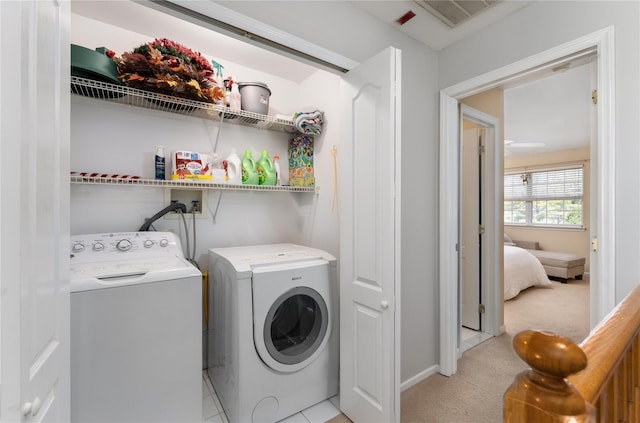 laundry room featuring independent washer and dryer, laundry area, visible vents, light carpet, and baseboards