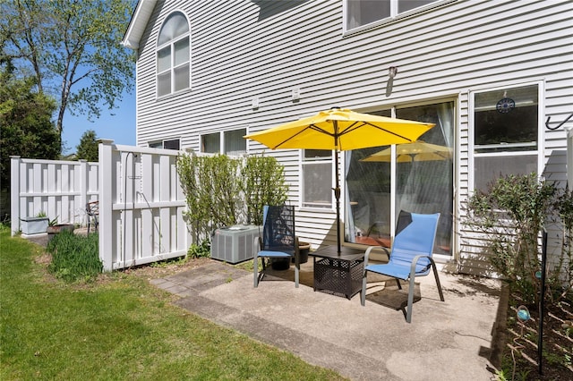 view of patio with fence and central AC