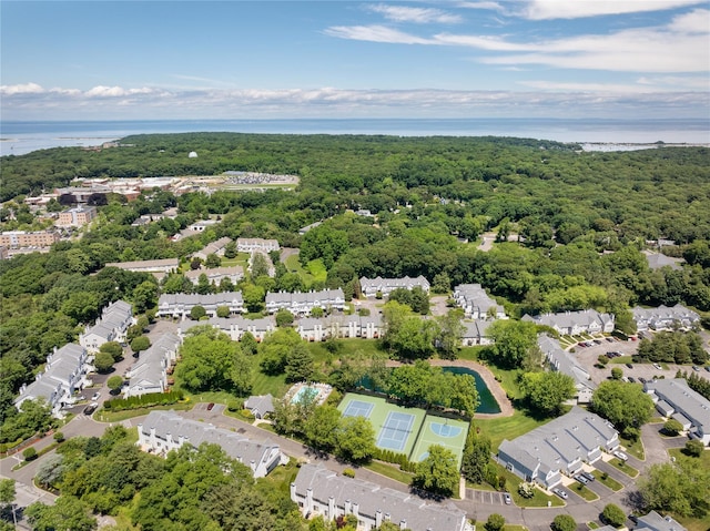 drone / aerial view with a water view and a view of trees