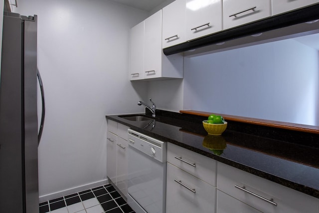 2373 Broadway Unit 602, New York Manhattan, NY 10024 - kitchen featuring white dishwasher, freestanding refrigerator, a sink, white cabinetry, and dark tile patterned floors