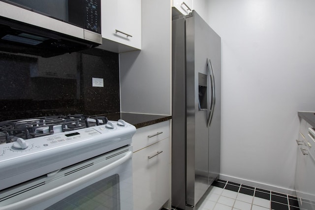 2373 Broadway Unit 602, New York Manhattan, NY 10024 - kitchen with stainless steel appliances, white cabinets, light tile patterned flooring, tasteful backsplash, and baseboards