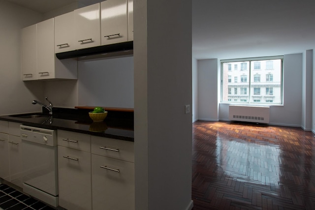 2373 Broadway Unit 602, New York Manhattan, NY 10024 - kitchen featuring dishwasher, radiator, dark countertops, a sink, and white cabinets