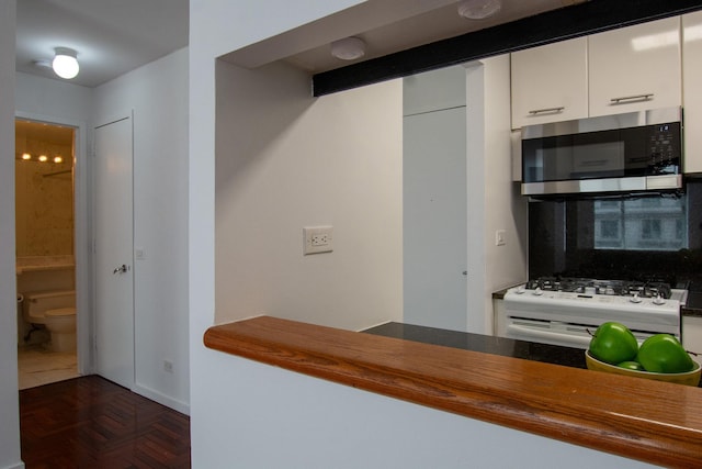 2373 Broadway Unit 602, New York Manhattan, NY 10024 - kitchen with stainless steel microwave, white range with gas stovetop, and white cabinetry