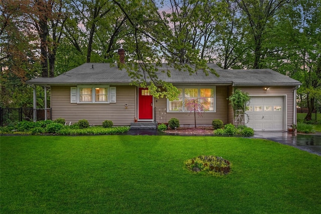 single story home featuring an attached garage and asphalt driveway