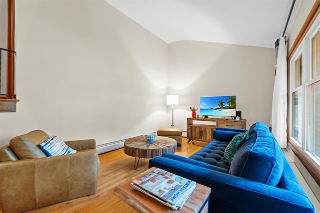 living area featuring baseboard heating, vaulted ceiling, a baseboard heating unit, and wood finished floors
