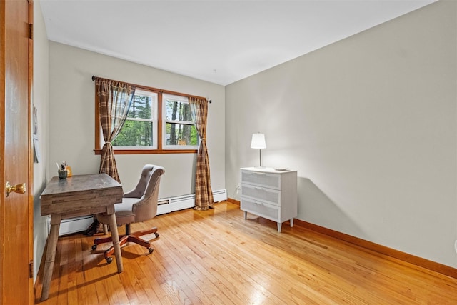 office with light wood-style floors, a baseboard radiator, baseboards, and baseboard heating