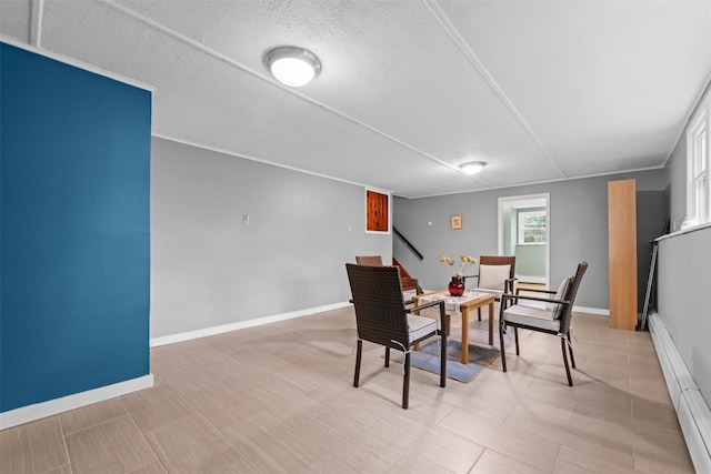 dining area with a baseboard radiator, stairway, and baseboards