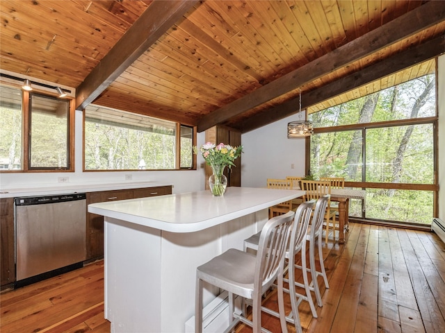 kitchen with dishwasher, light wood finished floors, light countertops, a kitchen island, and wooden ceiling