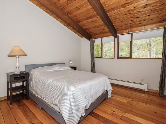 bedroom with a baseboard heating unit, wooden ceiling, wood-type flooring, and baseboards