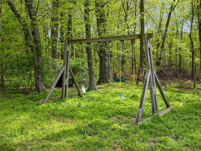 view of play area featuring a wooded view