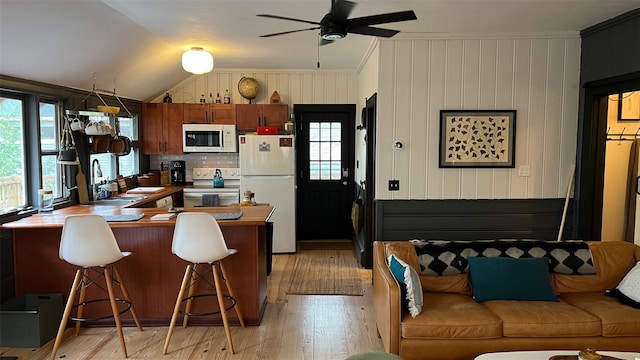 112 E Thompson Pl, Smallwood, NY 12778 - kitchen featuring white appliances, a sink, plenty of natural light, light wood-style flooring, and vaulted ceiling