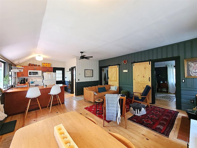 112 E Thompson Pl, Smallwood, NY 12778 - living area with a barn door, light wood-style flooring, a ceiling fan, and lofted ceiling