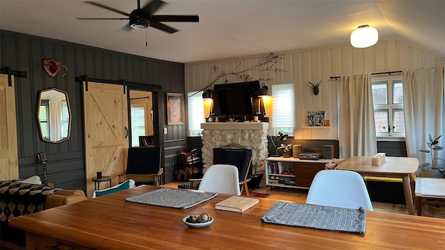 112 E Thompson Pl, Smallwood, NY 12778 - home office featuring a barn door, a ceiling fan, wood finished floors, a stone fireplace, and lofted ceiling