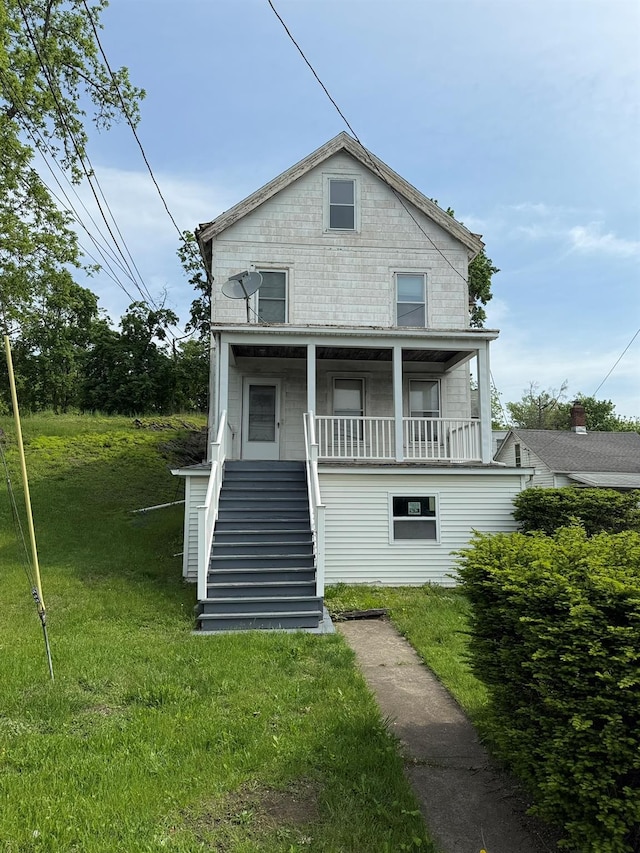 view of front of house featuring stairway, a front yard, and a porch