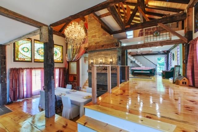 5 Downer Ln, Woodstock, NY 12498 - interior space featuring a notable chandelier, beam ceiling, stairs, and high vaulted ceiling