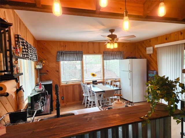51 E Oak St, Smallwood, NY 12778 - kitchen with freestanding refrigerator, ceiling fan, wood walls, beamed ceiling, and decorative light fixtures