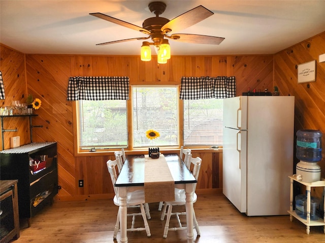 51 E Oak St, Smallwood, NY 12778 - dining space featuring wooden walls, light wood-style flooring, and a ceiling fan