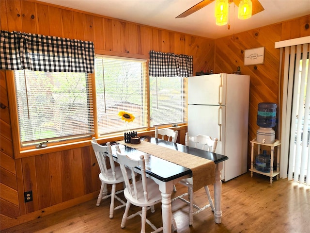 51 E Oak St, Smallwood, NY 12778 - dining space featuring wooden walls, healthy amount of natural light, light wood-type flooring, and a ceiling fan