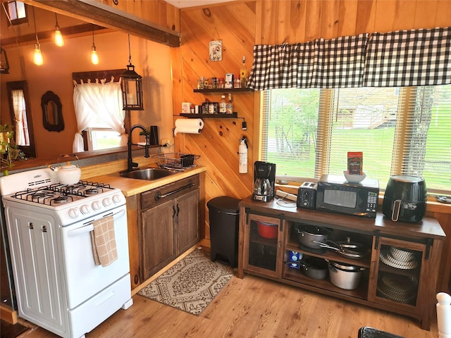 51 E Oak St, Smallwood, NY 12778 - kitchen with gas range gas stove, a sink, black microwave, light wood-type flooring, and open shelves