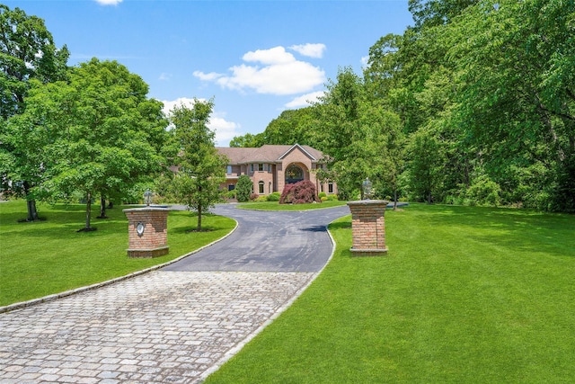 9 Oak Ridge Ct, West Harrison, NY 10604 - view of front of property featuring curved driveway and a front yard