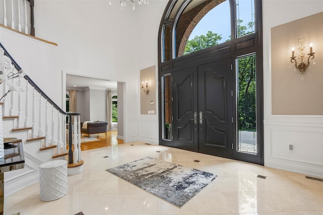 9 Oak Ridge Ct, West Harrison, NY 10604 - foyer entrance with a decorative wall, stairway, a towering ceiling, and a wainscoted wall